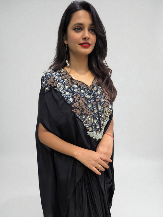 Woman in Designer Black Cape with Hand Embroidery, showcasing festive elegance and style by Ambika Boutique.