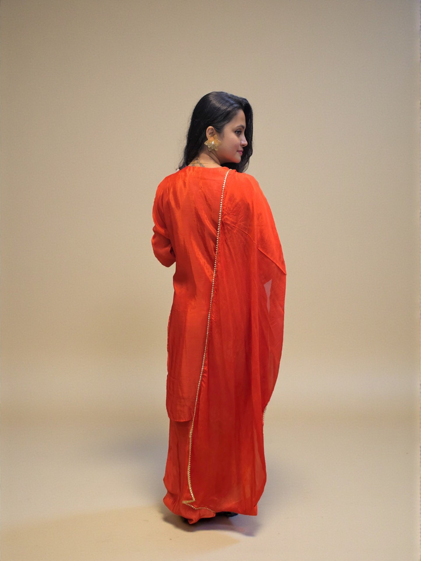 Premium rust orange kurta palazzo set featuring detailed hand embroidery