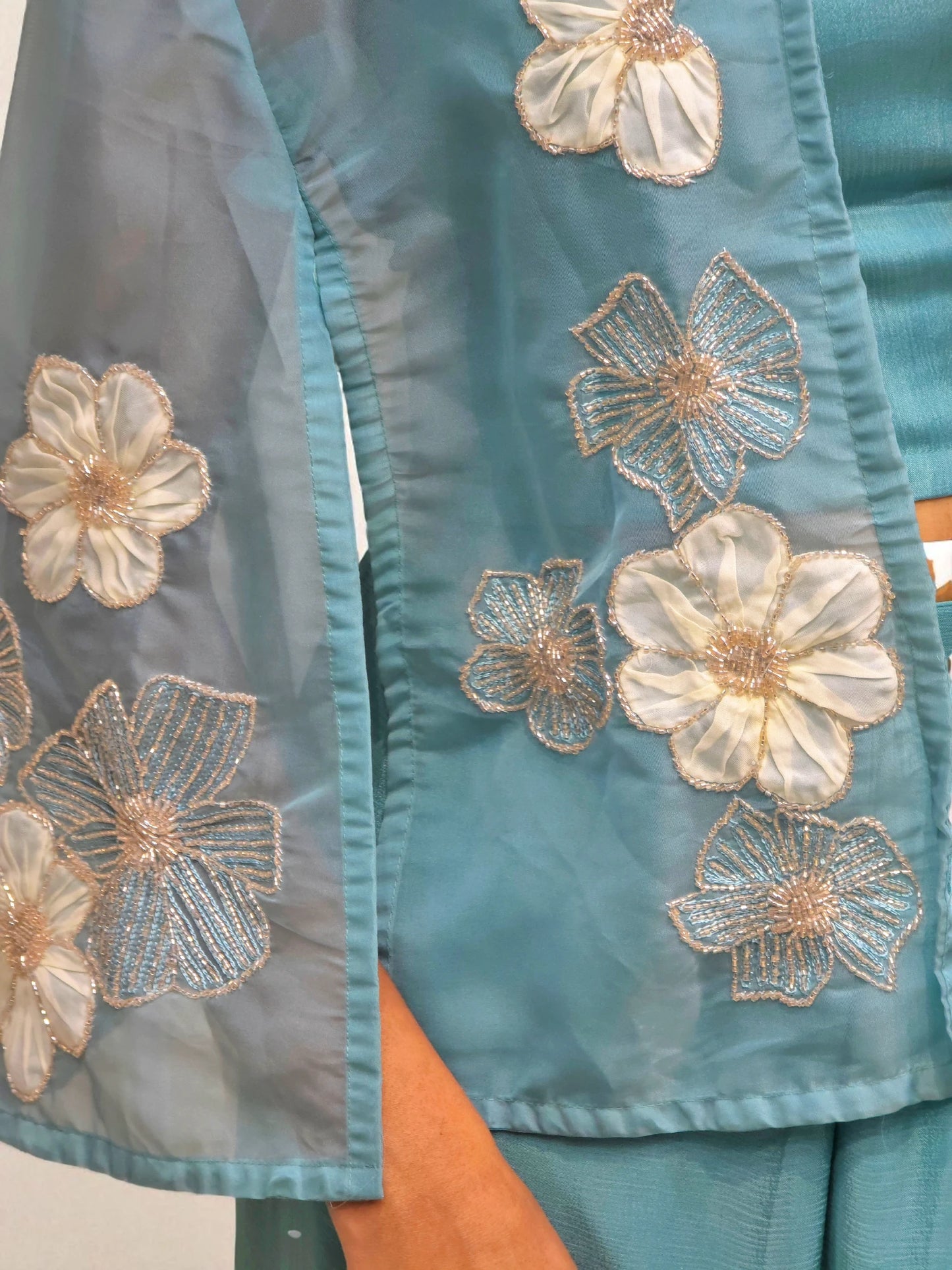 Blue crop top with dhoti skirt and organza shrug featuring applique handwork – Ambika Boutique