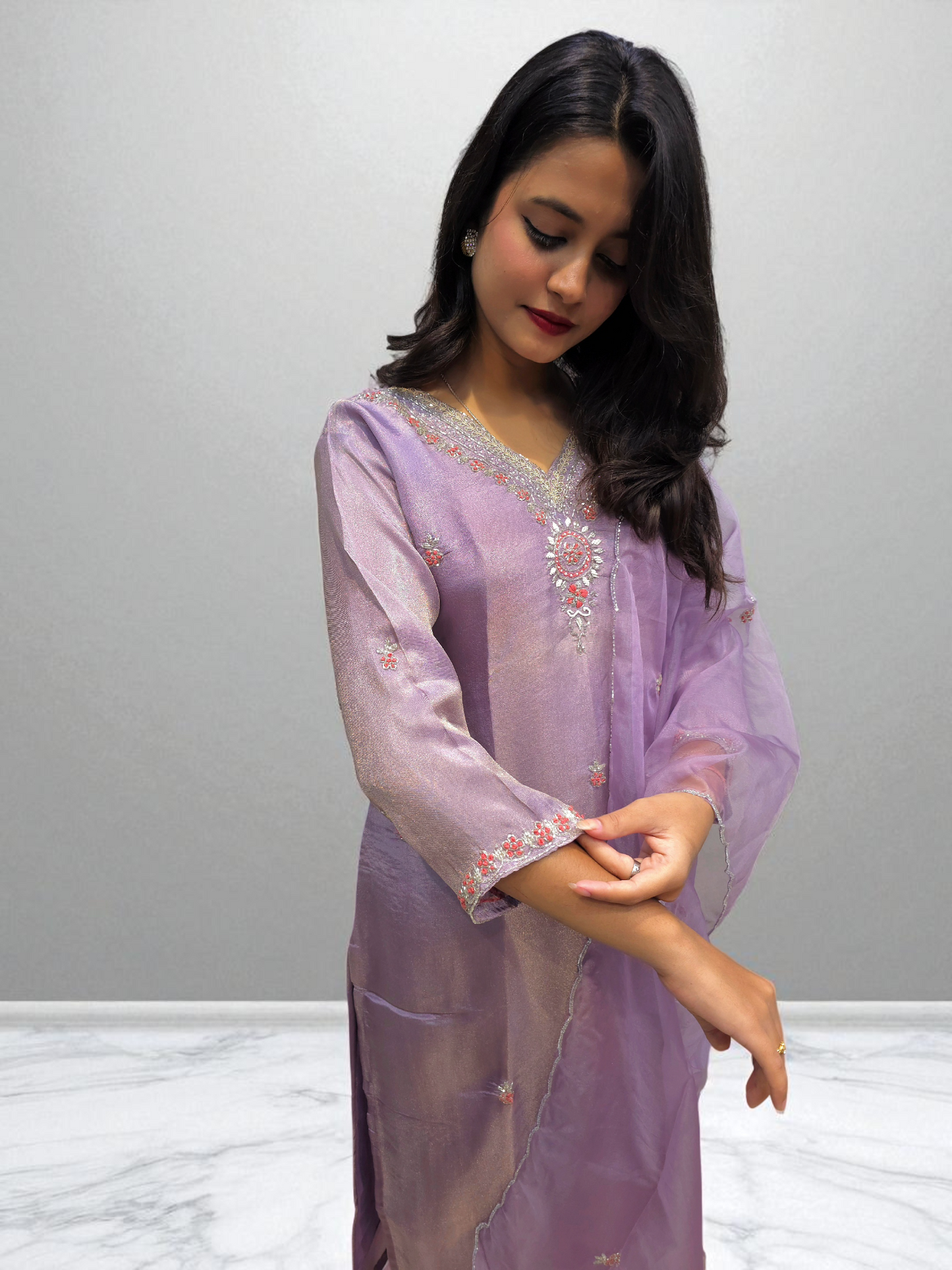 Model wearing a lavender handwork kurta set featuring exquisite embroidery, perfect for party wear and special occasions.