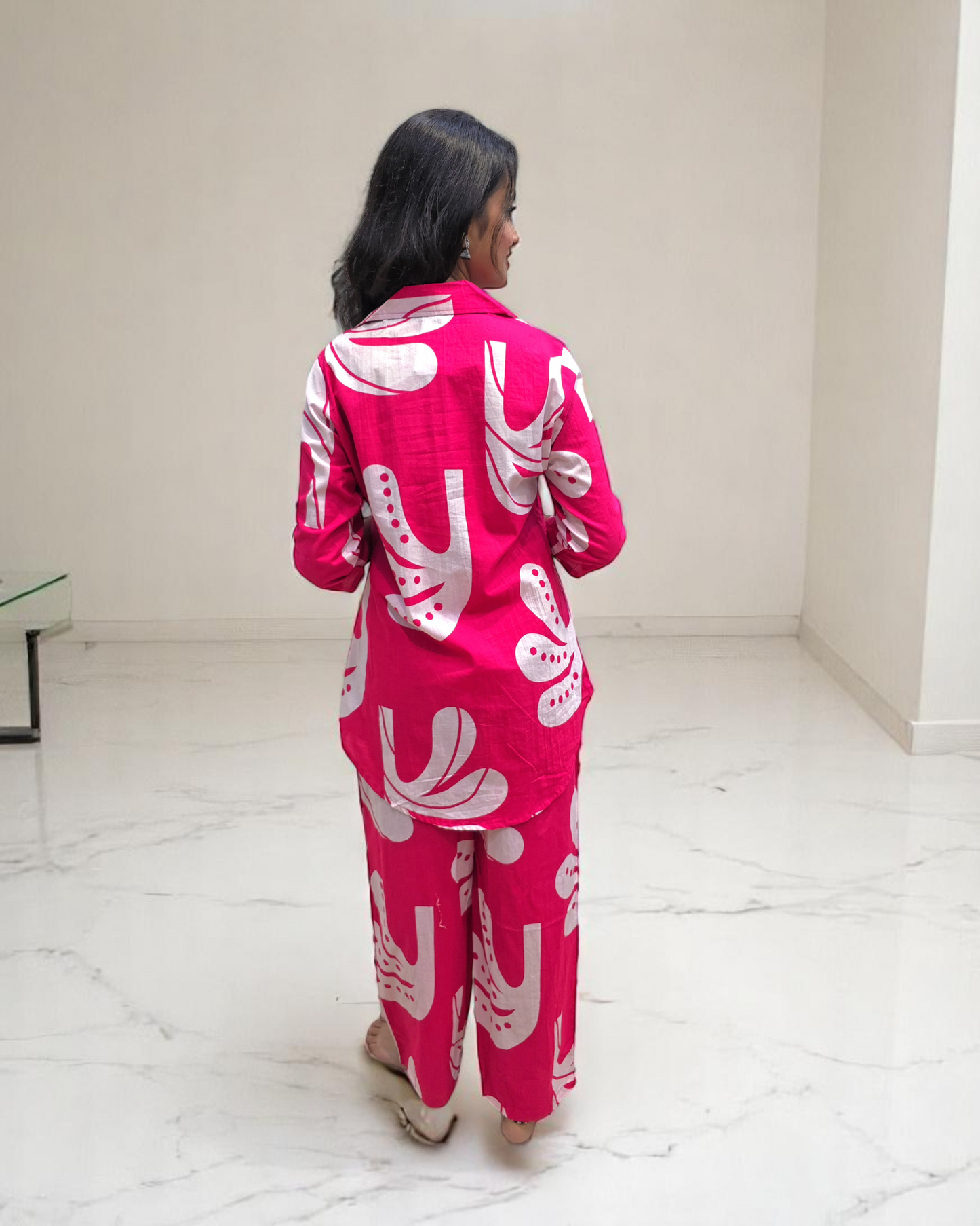 Back view of a woman in a pink printed cotton co-ord set, ideal for summer office wear from Ambika Boutique.