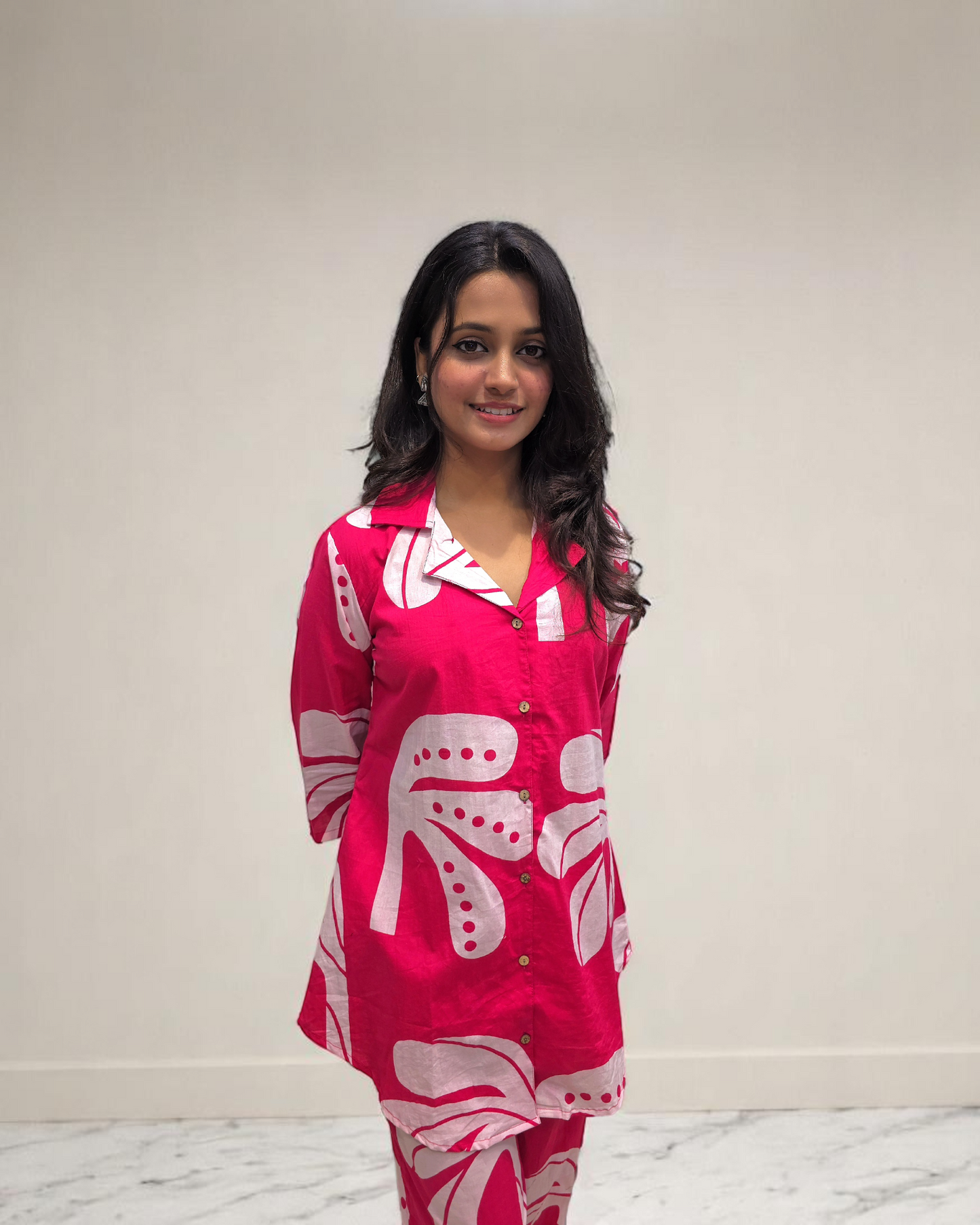 Woman in a pink printed cotton co-ord set, showcasing stylish office wear from Ambika Boutique.