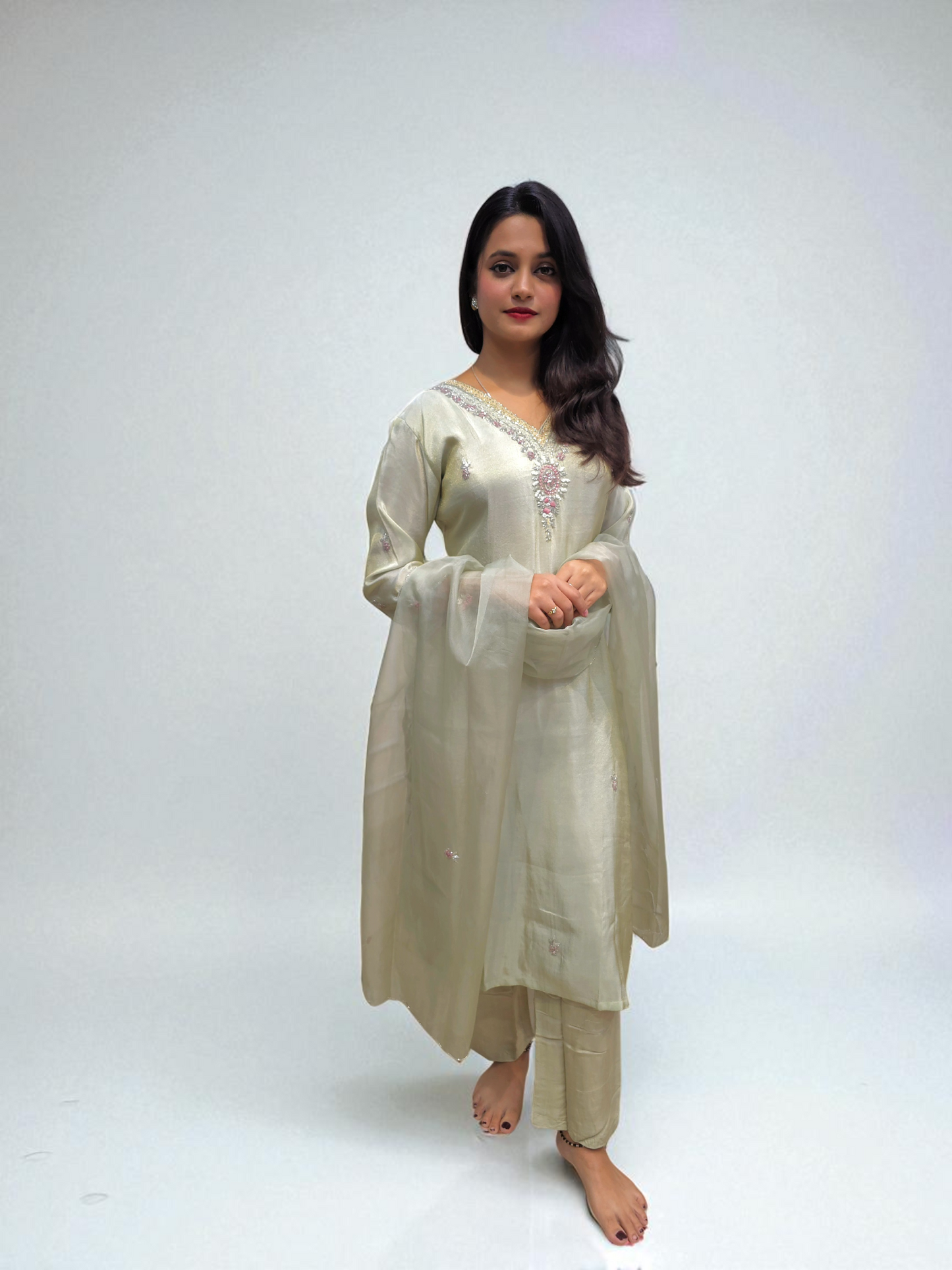 Model wearing a ivory Pure Shimmer Tissue Kurta Set with elegant handwork, paired with a matching organza dupatta.