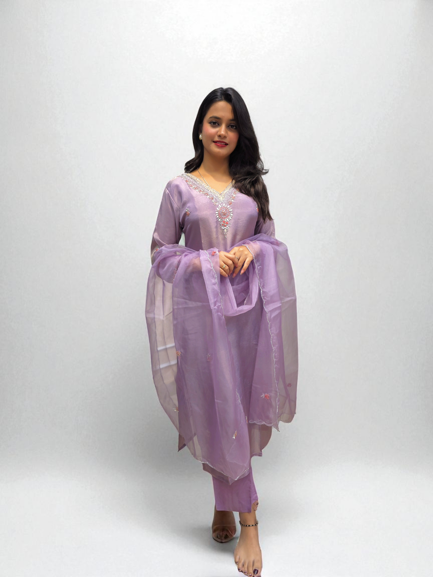Model wearing a lavender Pure Shimmer Tissue Kurta Set with elegant handwork, paired with a matching organza dupatta.