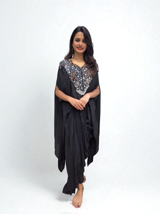 Woman wearing Designer Black Cape Dhoti Skirt Set with Hand Embroidery – Festive Outfit by Ambika Boutique.