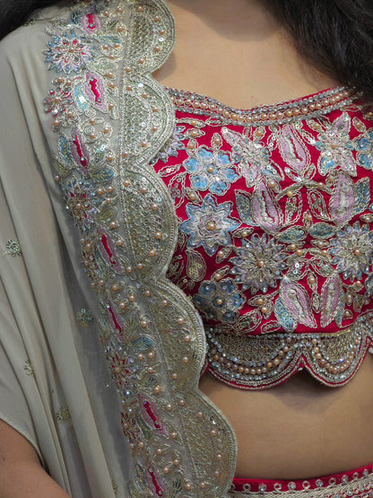 Embroidered crop top paired with maroon dhoti skirt and beige shrug