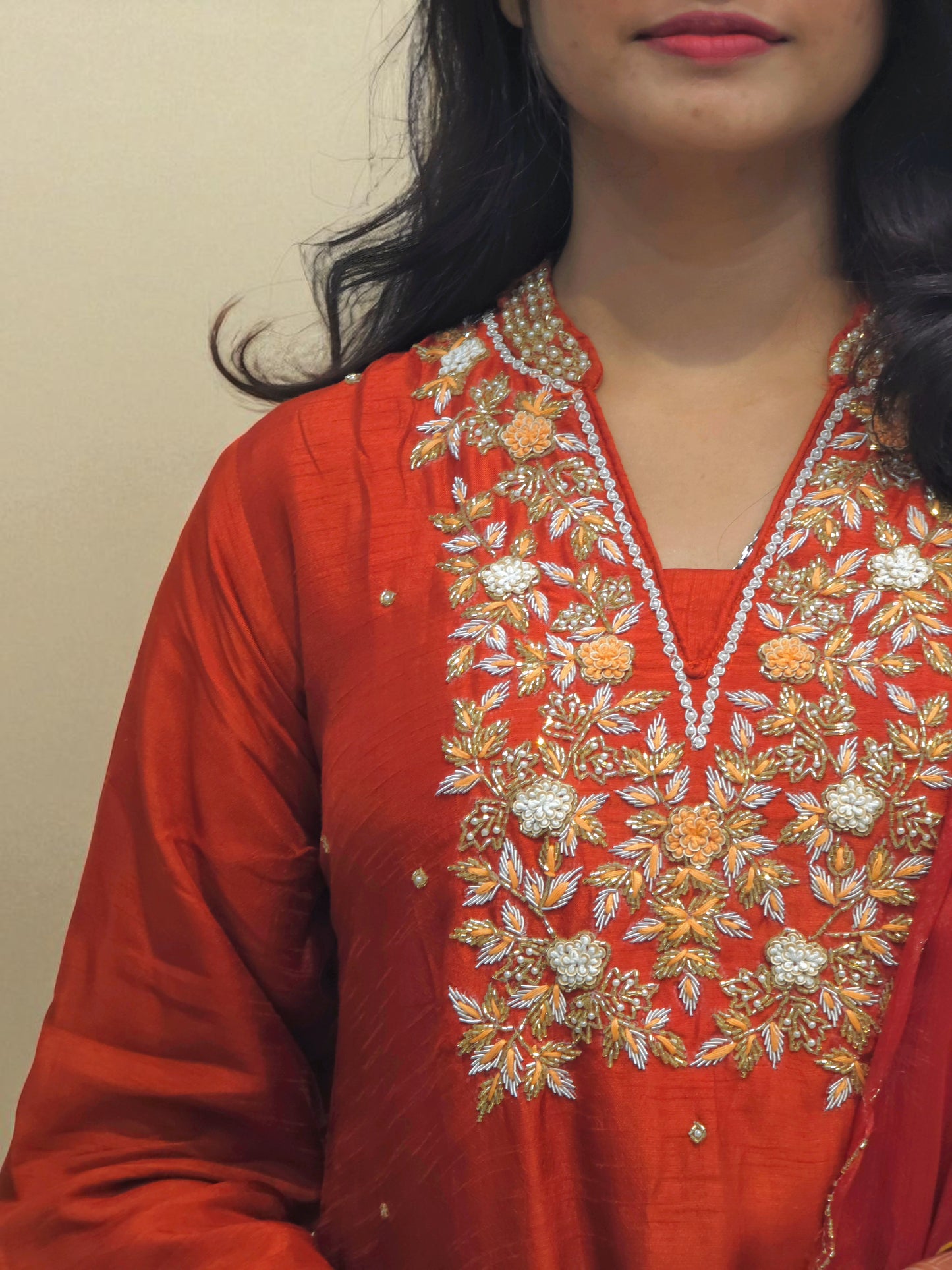 Handcrafted rust orange ethnic outfit with detailed neckline embroidery