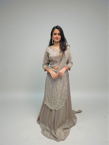 Woman wearing heavy handwork crop top lehenga with drape dupatta