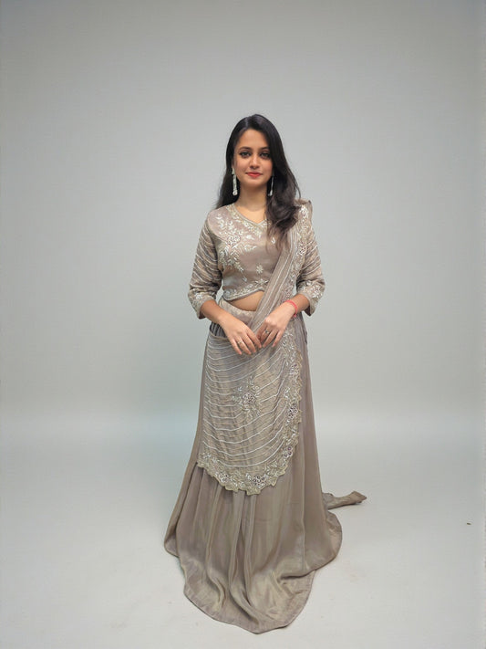 Woman wearing heavy handwork crop top lehenga with drape dupatta