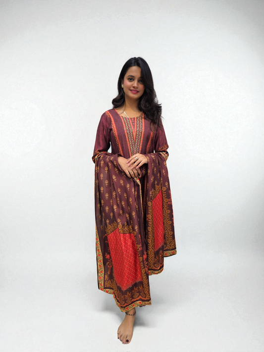 Woman wearing a patterned dress with red and brown colors on a white background