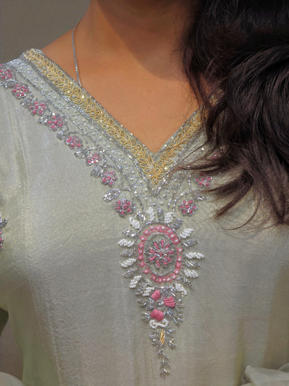 Elegant ivory kurta set featuring intricate handwork and shimmering fabric, perfect for party wear and special occasions.