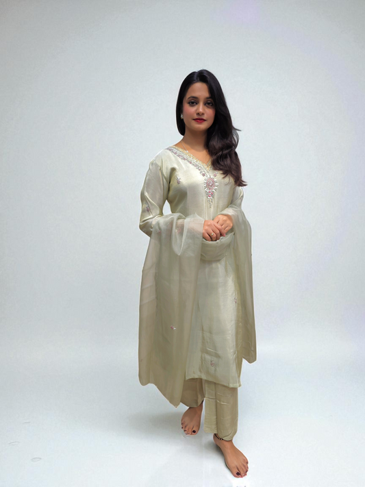 Model wearing a ivory Pure Shimmer Tissue Kurta Set with elegant handwork, paired with a matching organza dupatta.